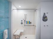 Bathroom with shower and shower seat