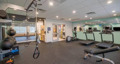 Fitness center with cardio machines and bench