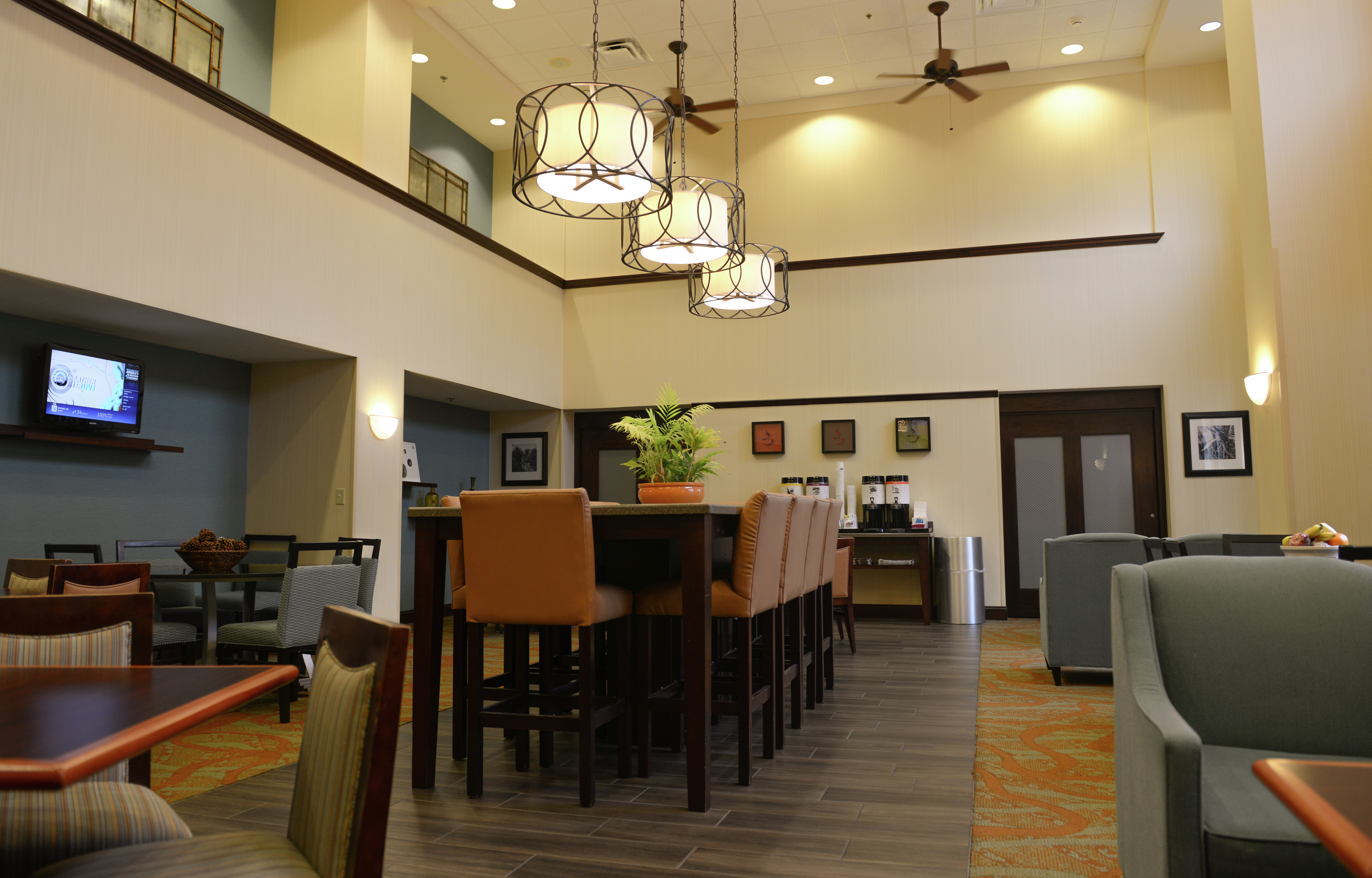 Dining Tables, Chairs, Hot Beverage Station, and TV in Lobby Seating Area