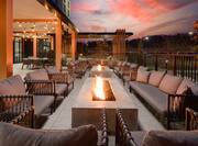 Patio Area at Sunset with Sofas Around Two Fire Pits