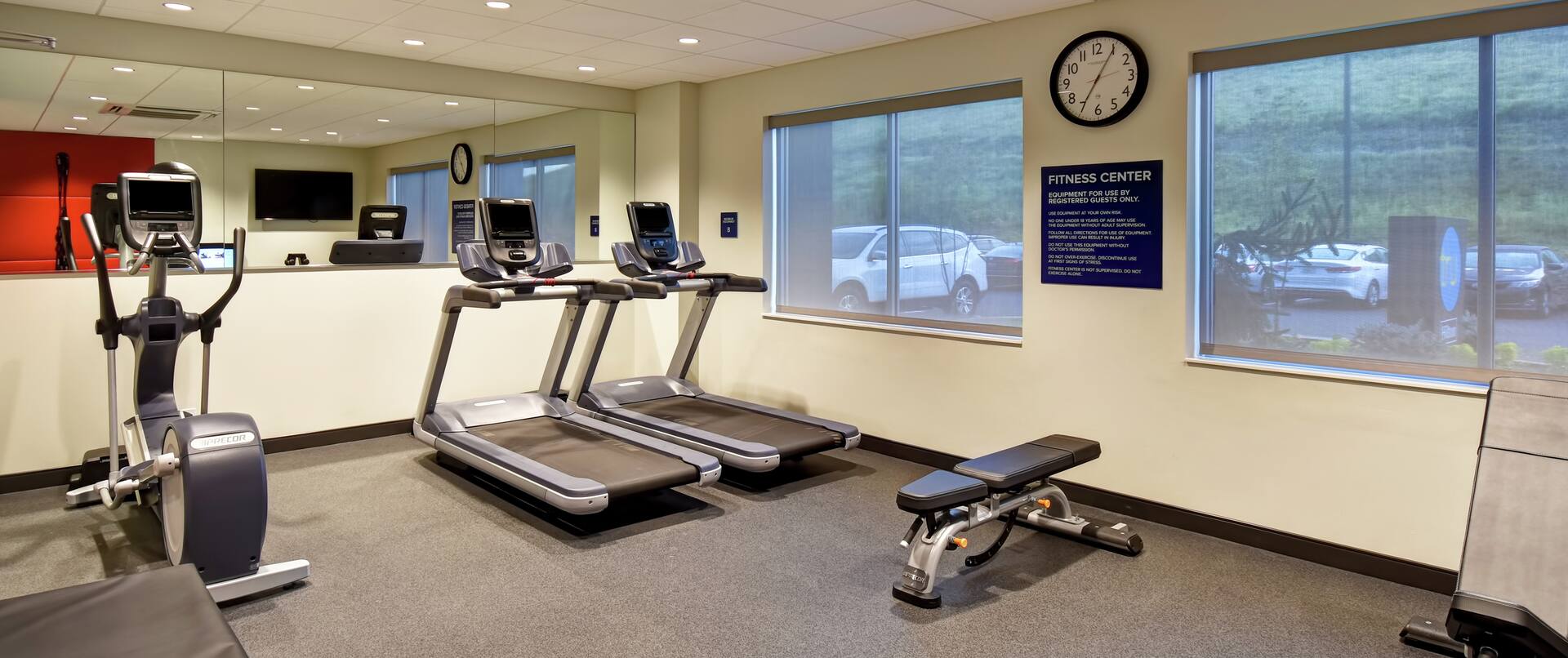 Fitness room with equipment and windows
