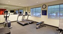 Fitness room with equipment and windows