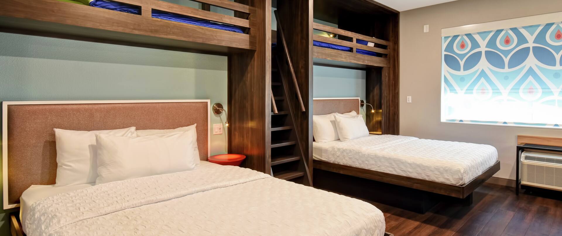 Two queen beds and two twin beds in a hotel room