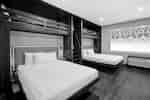 Two queen beds and two twin beds in a hotel room