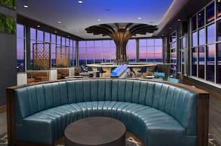 Radius Rooftop Lounge with View of Sunset from Large Windows