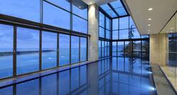 Indoor Swimming Pool with Large Windows Offering Sea View