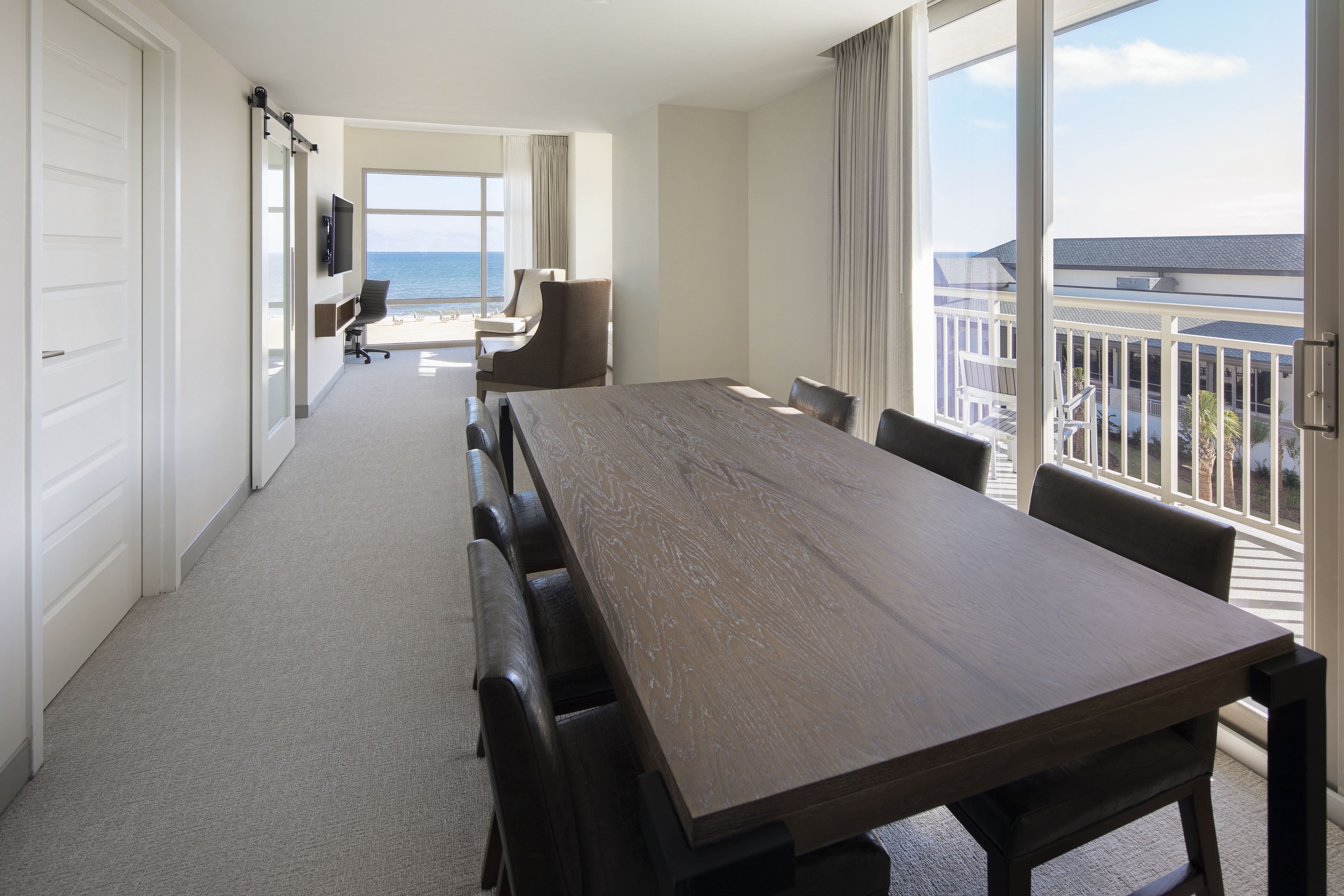 Corner Suite with Community Table, Lounge Area, Outside View, and Room Technology