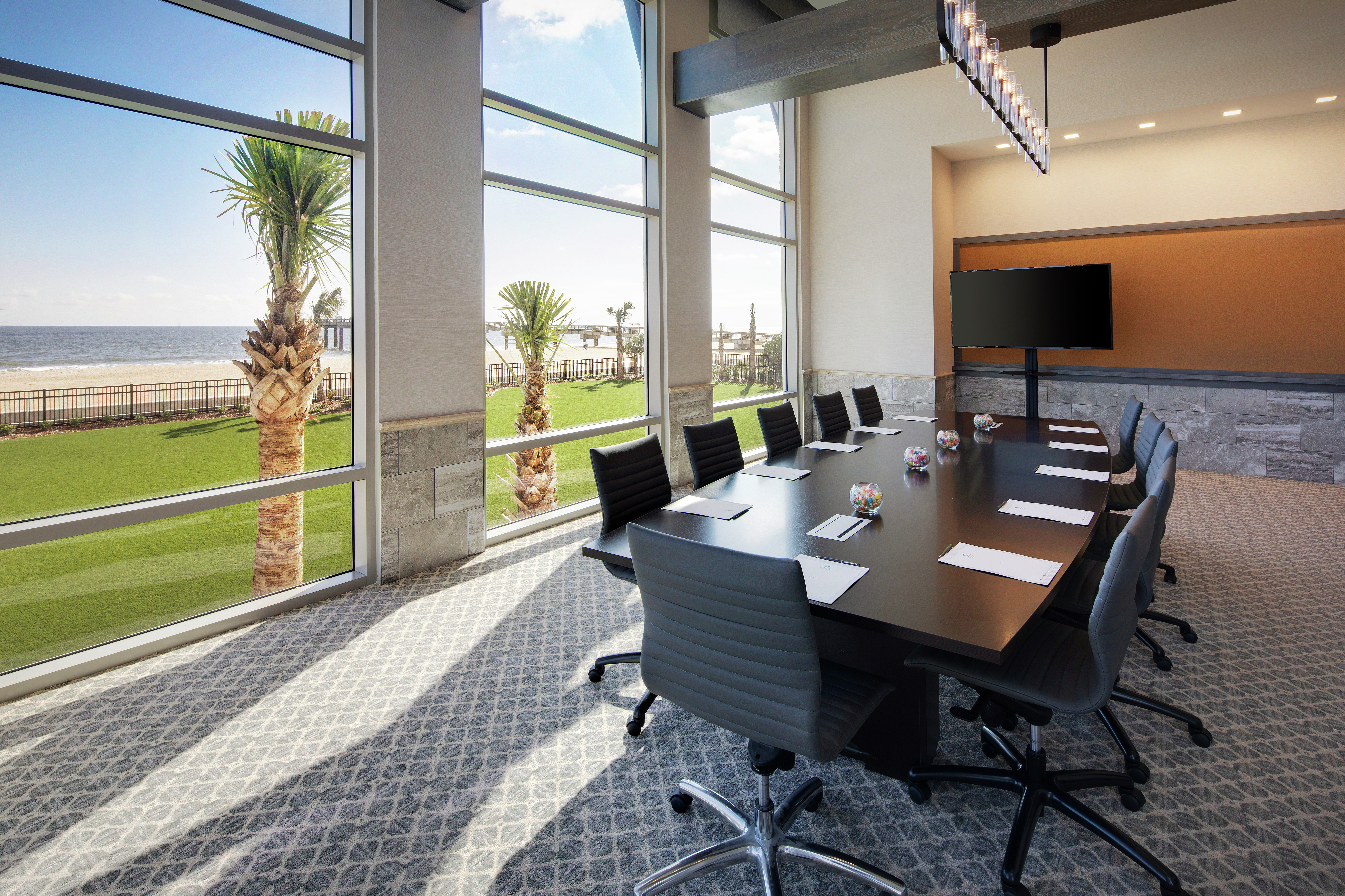 Conference Table, Chairs, and Monitor in Surf Crest Boardroom with Ocean View