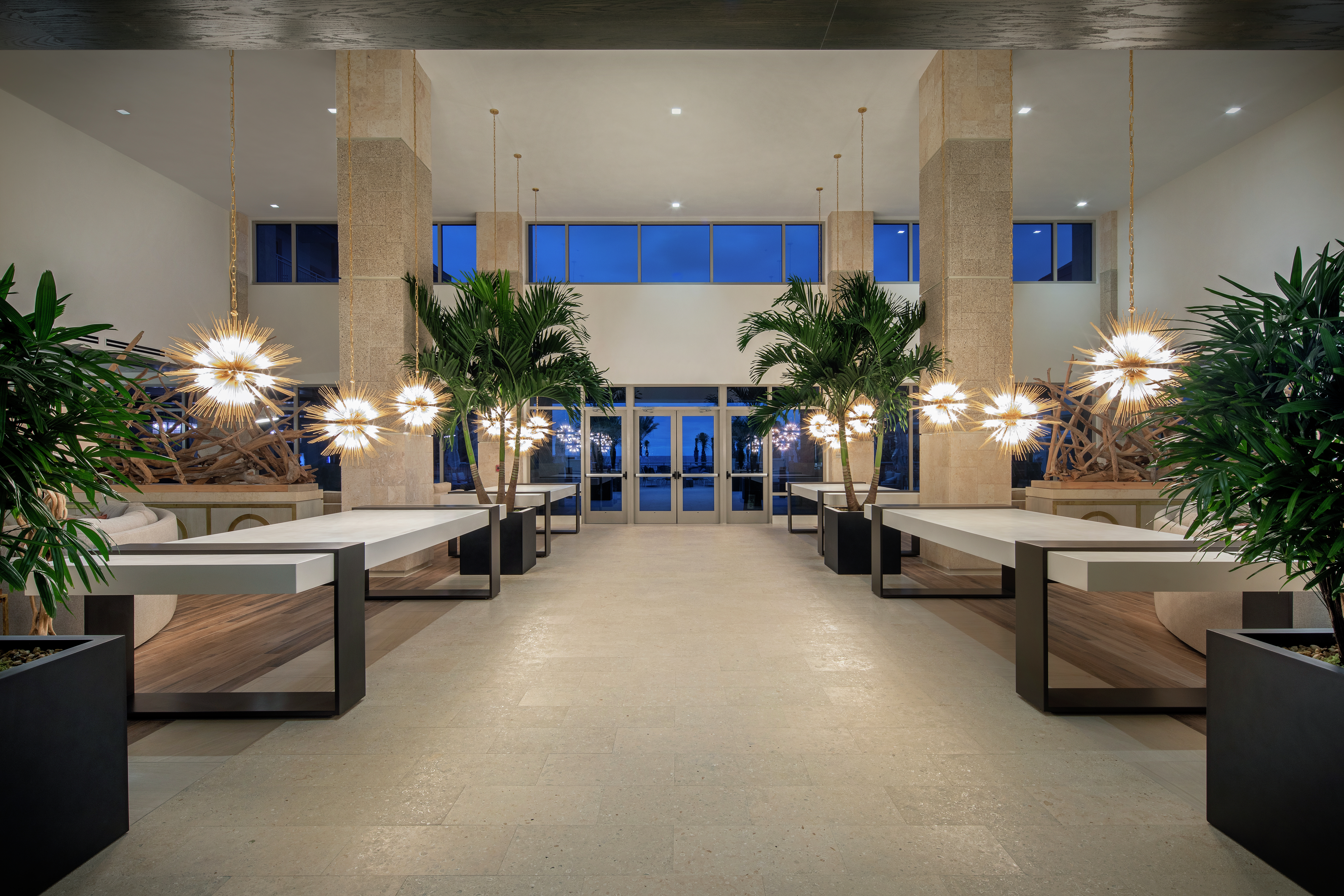 View of Front Entrance, Contemporary Light Fixtures, and Furnishings in Hotel Lobby