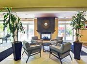 Lobby casual seating area with chairs, coffee tables, and fireplace