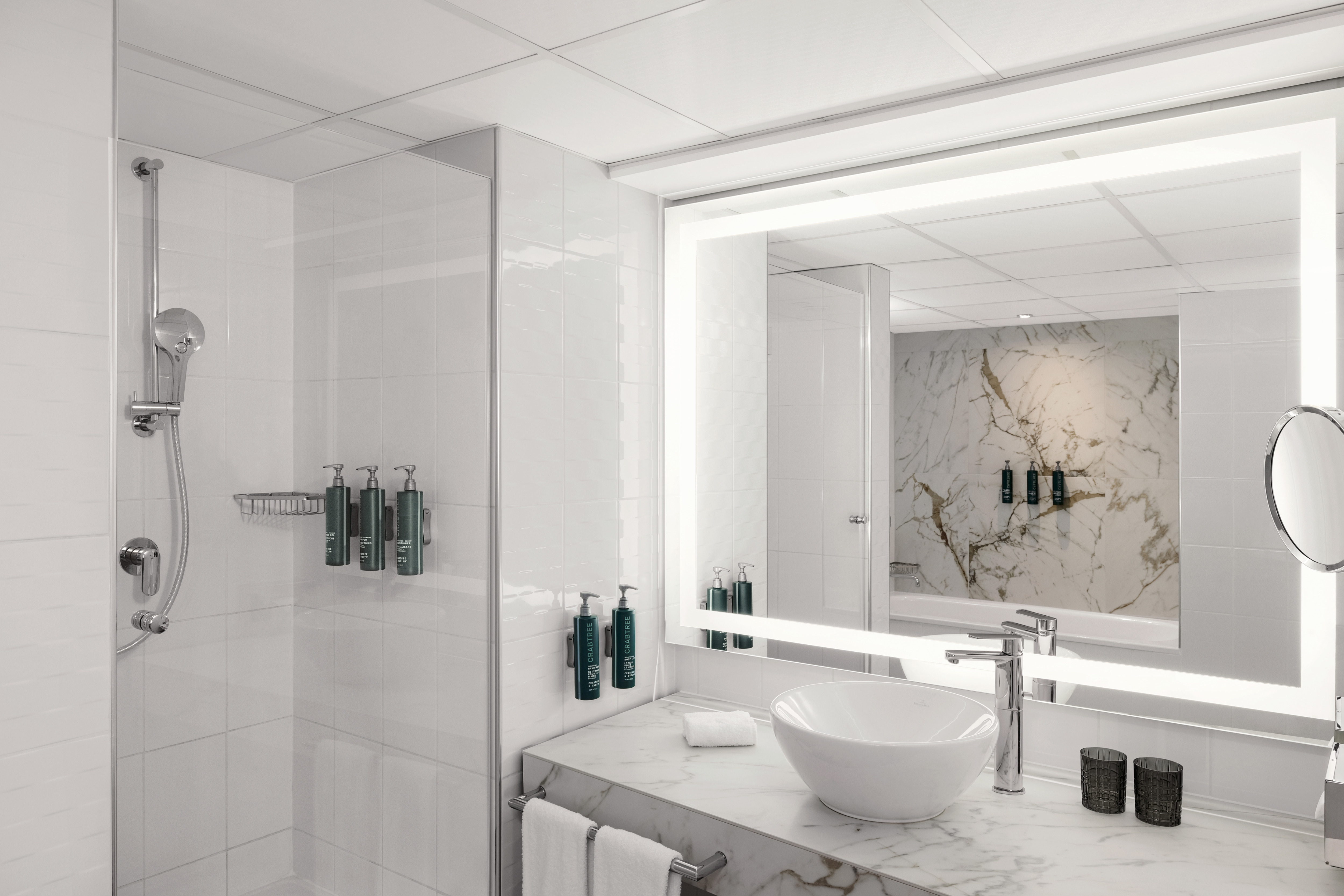 Vanity Area and Shower with Amenities in a Hotel Suite