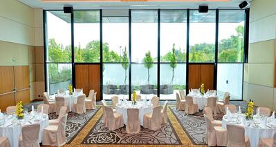 Meeting Room with Banquet Tables and Floor to Ceiling Windows