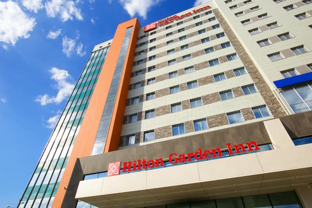 Daytime View of Hotel Exterior With Signage