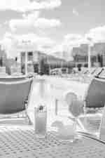 Cocktails sitting on a table near the pool. 