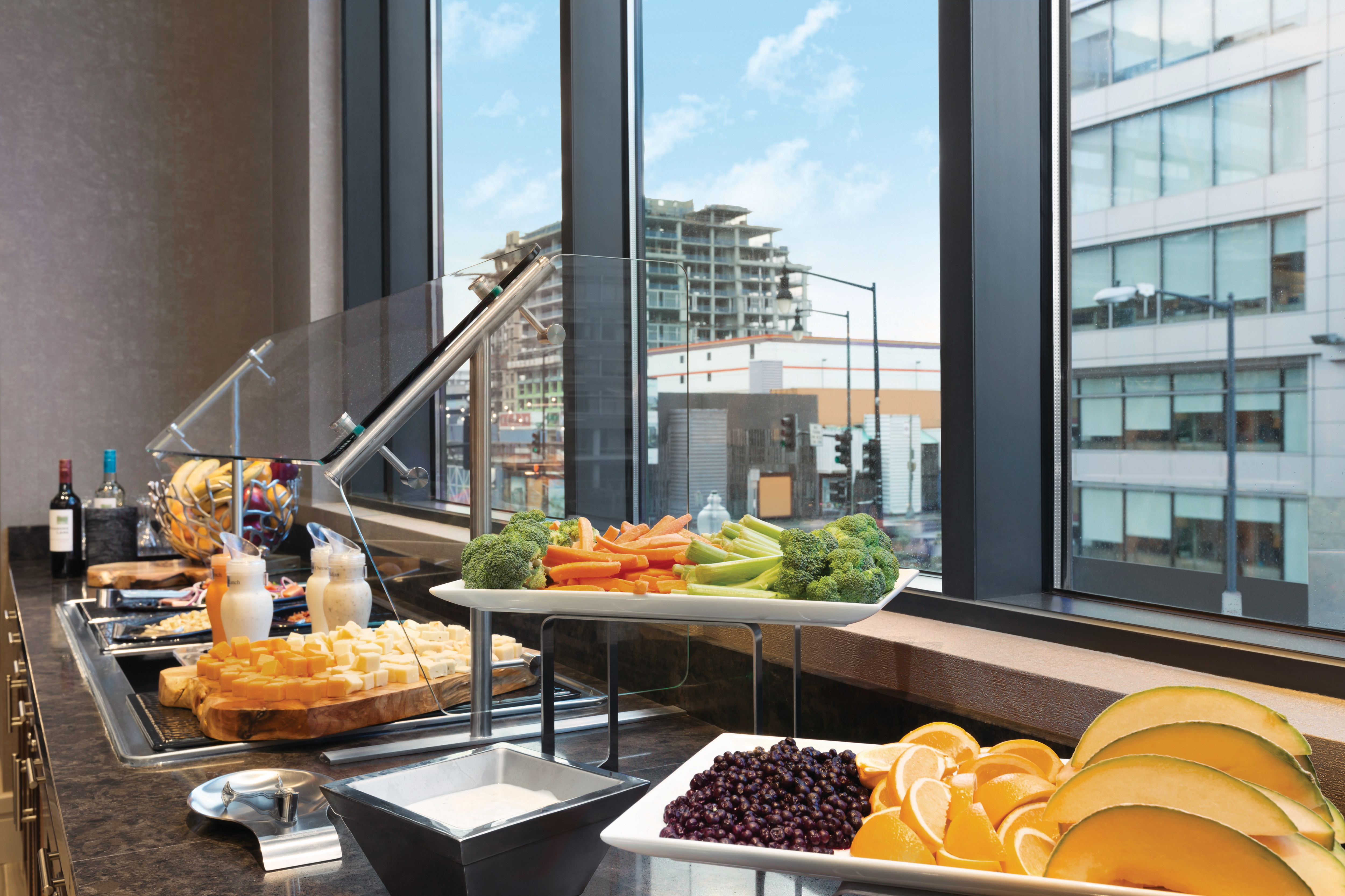 Wine, Cheese, Vegetable and Fruit Selections by Window at Evening SocialHealthy Options like Fresh Fruit, Yogurt and Granola at our Complimentary Breakfast Buffet