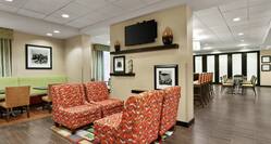 Lobby Seating Area with Chairs, Tables and Wall Mounted TV