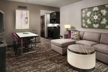 Embassy Suites King Living Room with Lounge Area, Table, and Room Technology