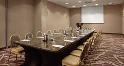 Embassy Suites Potomac Meeting Room with Table, Chairs, and Projector Screen