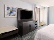 A large bed and HDTV in guest room