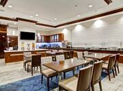 TV, Beverage and Buffet Selections With Table and Chair Seating in Lodge Area 