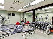 Fitness Center with Large Windows, Cardio Equipment, TV, and Full Length Mirror