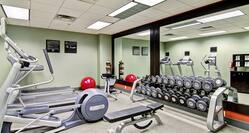 Fitness Center with Large Windows, Cardio Equipment, TV, and Full Length Mirror