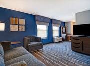 guest room with lounge area windows and television