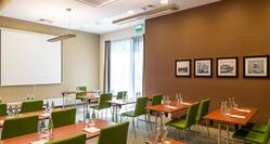 Hampton by Hilton Warsaw Airport Hotel, Poland - Green Chairs and Desks in Conference Room