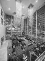 Pistaccio Bar & Lounge from above on walkway, showing vibrant red carpet and yellow armchairs. 