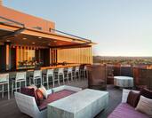 Sunset View of Lounge and Counter Seating at Fully Stocked Skybar