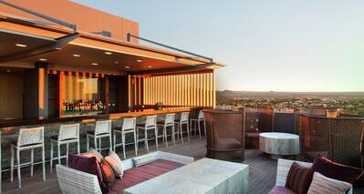 Sunset View of Lounge and Counter Seating at Fully Stocked Skybar