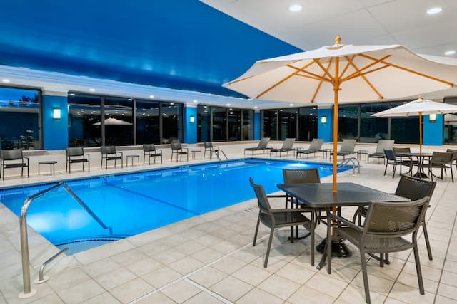 indoor pool, tables, chairs, umbrellas