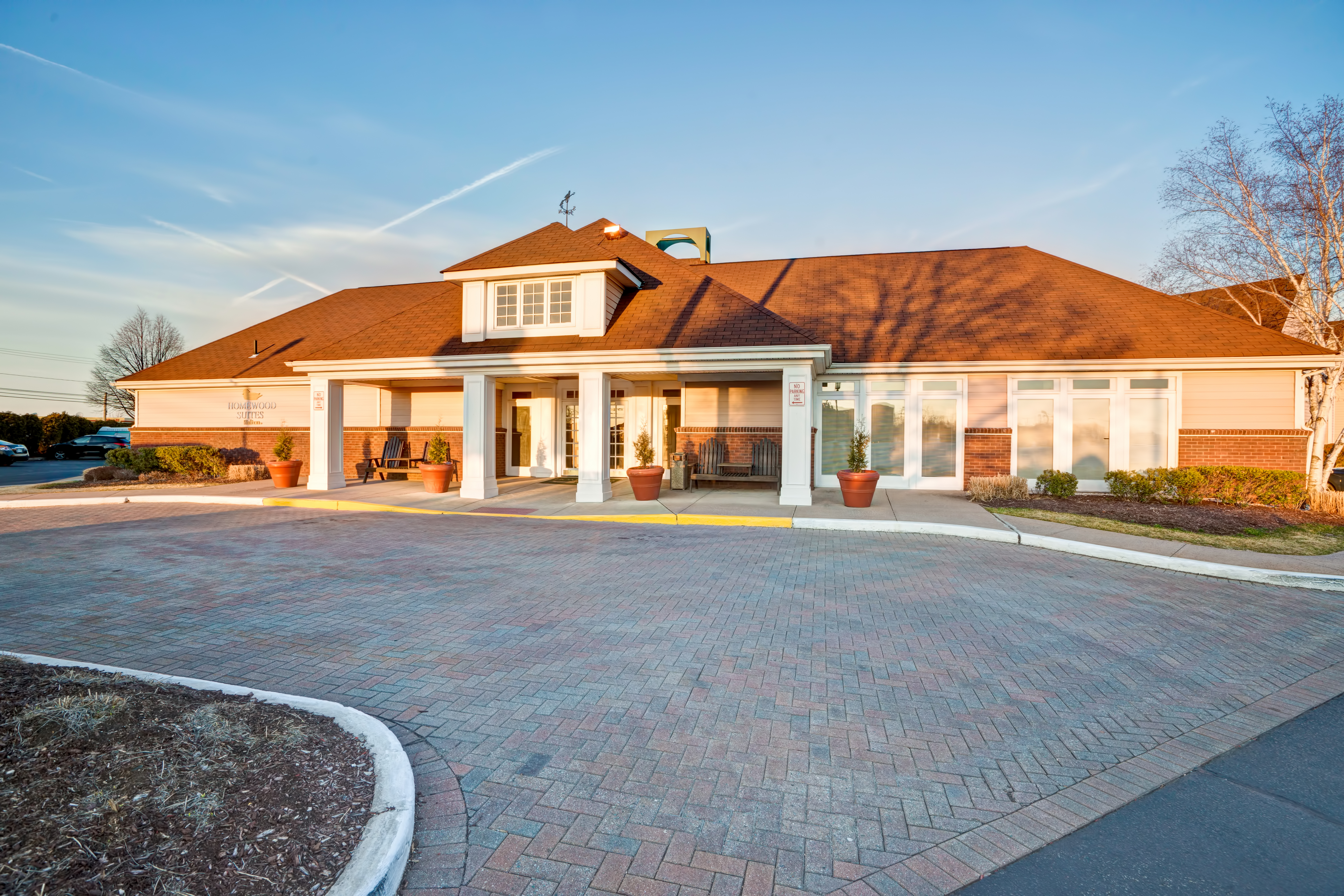 Daytime View of Hotel Exterior, Signage,  Landscaping, Circle Driveway, and Parking Lot