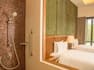 shower with view of twin beds