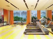 Fitness Center with Treadmills. Dumbbells, and Outside View