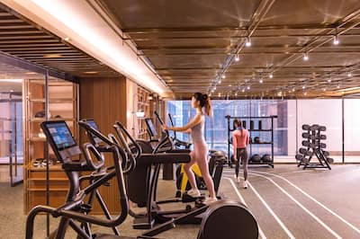 Two women working out in fitness center