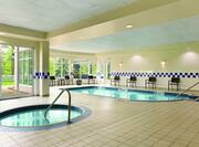 Heated Indoor Pool and Whirlpool With Chairs and Windows