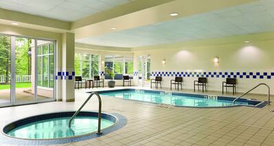 Heated Indoor Pool and Whirlpool With Chairs and Windows