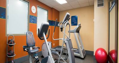 Fitness Center with Cycle Machine, Cross-Trainer and Treadmill, Gym Ball and Medicine Ball Rack