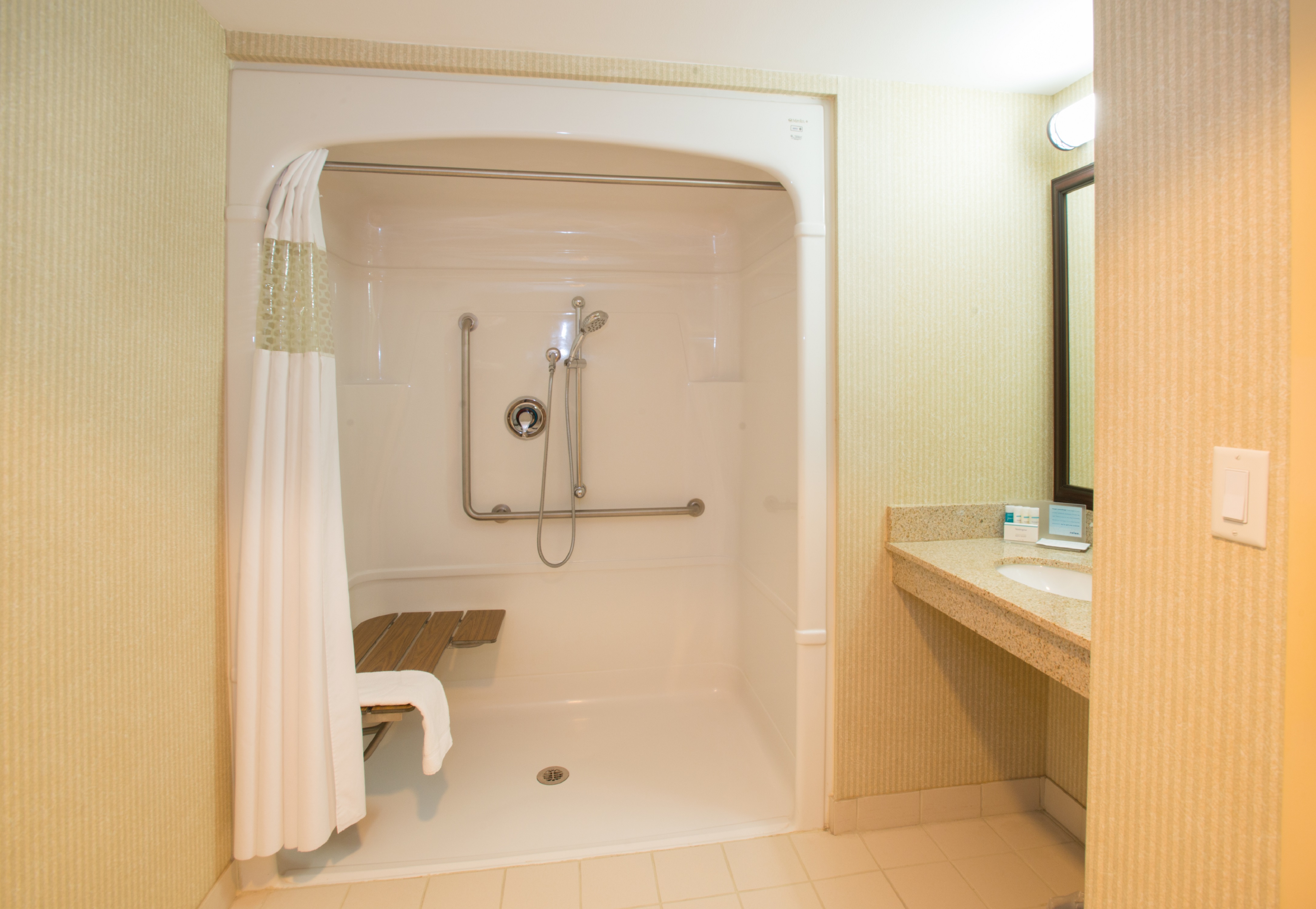 Accessible Bathroom with Roll-In Shower, Bench and Vanity