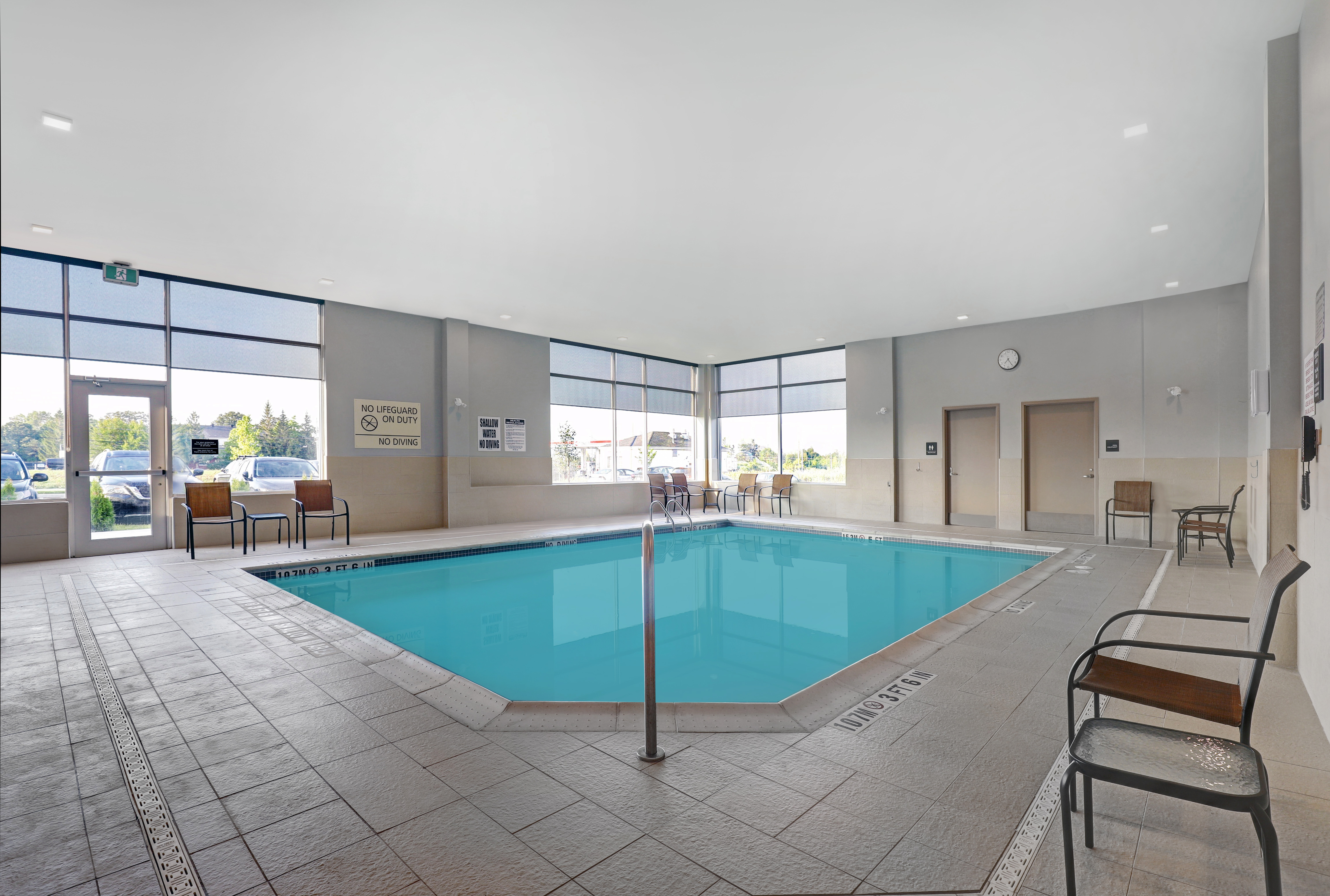 indoor pool and seating with windows