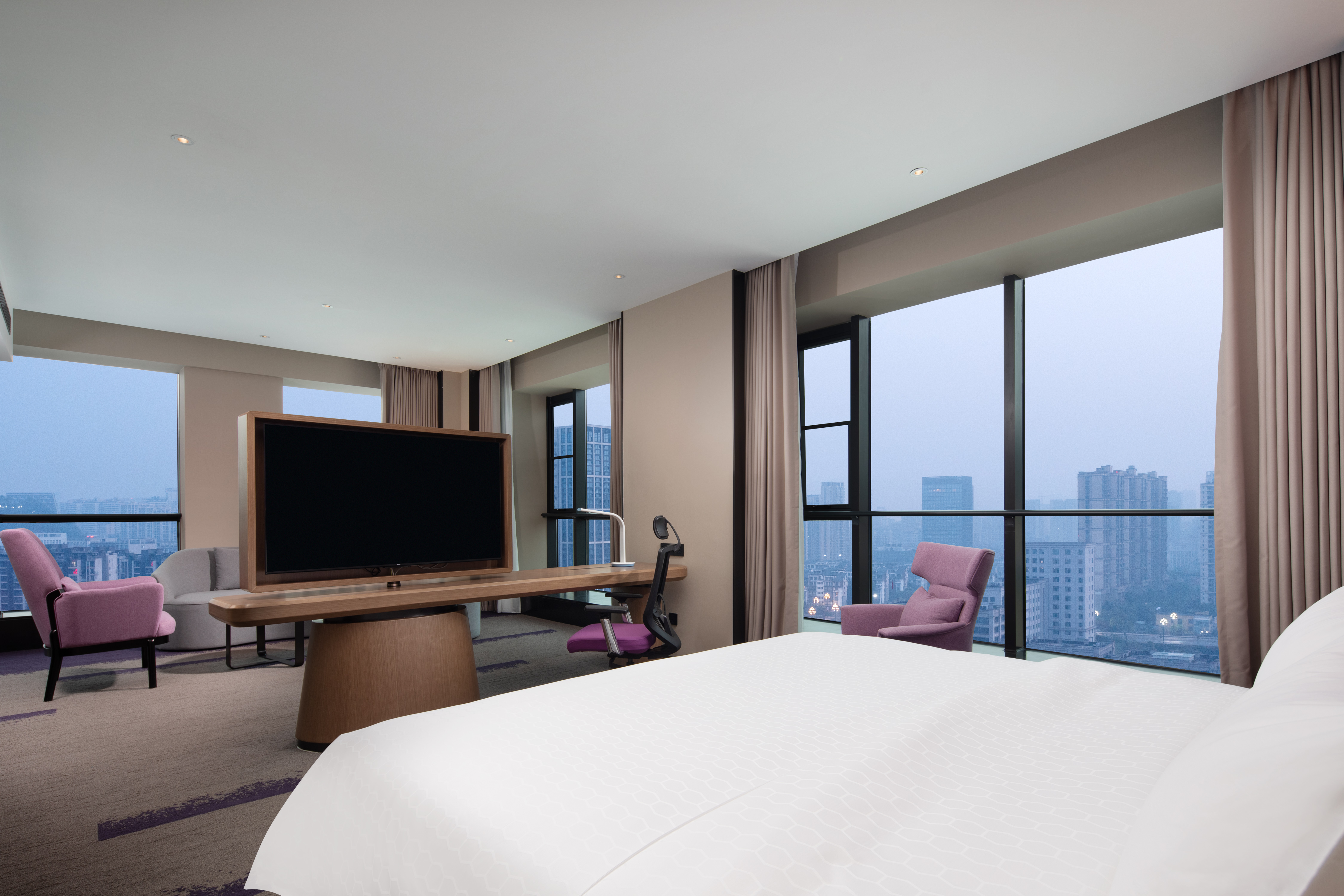 guest suite, 1 king bed, tv, work desk, window view of the city