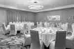 Meeting room set in banquet style, with round tables.