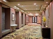 Hallway Outside of Meeting Room With Soft Seating and Decorative Tables