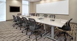 Conference Center With Windows, TV, Whiteboard, and Seating for 10 Around Boardroom Table