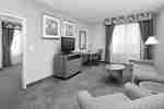 Suite Living Area with Sofa Round Table Armchair Desk and TV