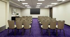 Meeting Room with Rows of Chairs and Wall Mounted TV