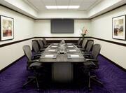 Boardroom with Office Chairs, Meeting Table and Wall Mounted TV