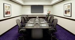 Boardroom with Office Chairs, Meeting Table and Wall Mounted TV