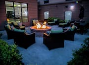 Patio Seating Area with Fire Pit Table at Night